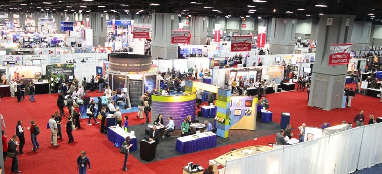 Crowded exhibition hall at the Society for Neuroscience annual meeting, seen from above.